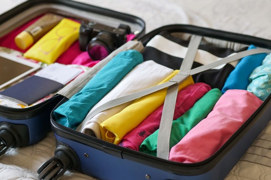 Open suitcase packed with colorful clothes