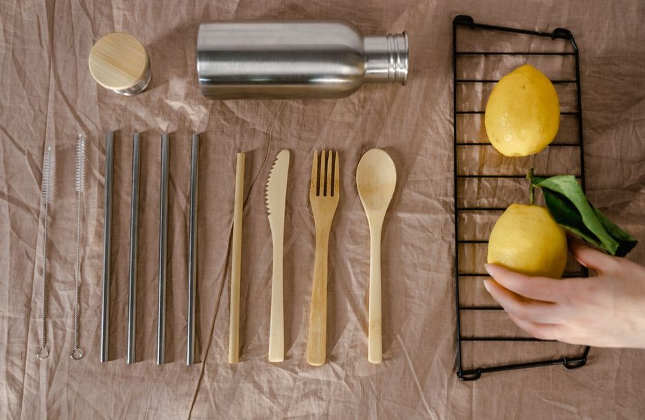 Wooden kitchen utensils and a lemon on a work surface